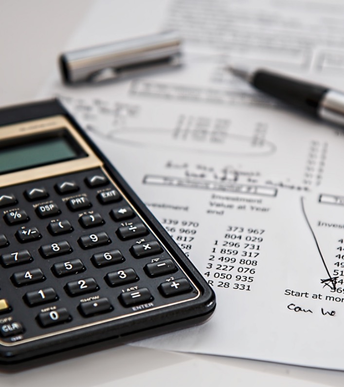 A calculator and a pen on a printed financial statement